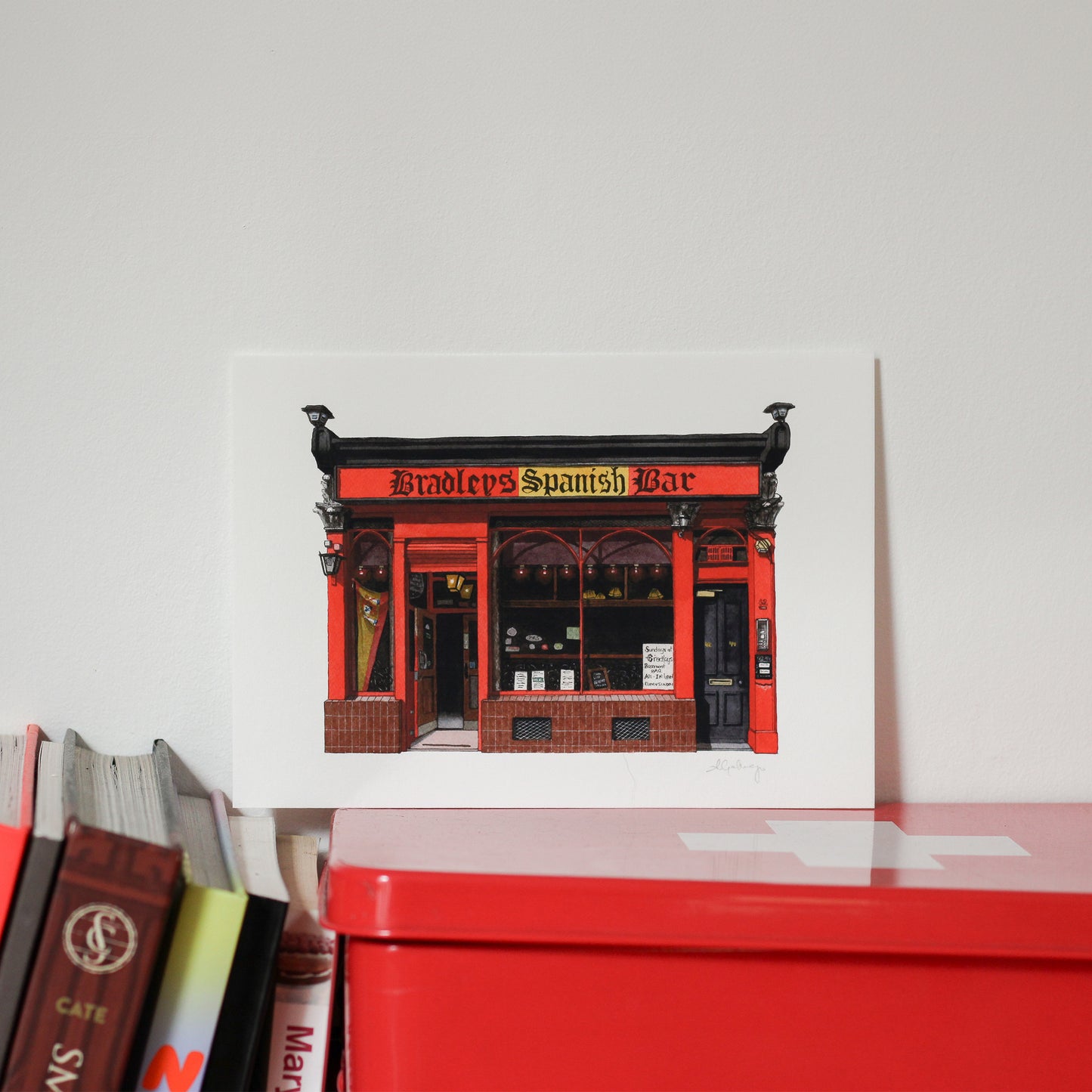 Red and black building facade with 'Bradley's Spanish Bar' text on a white background