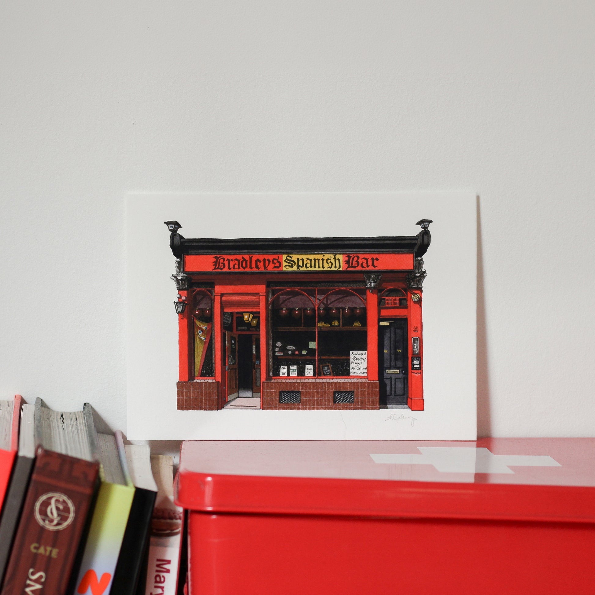 Red and black building facade with 'Bradley's Spanish Bar' text on a white background