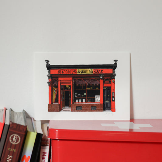 Red and black building facade with 'Bradley's Spanish Bar' text on a white background