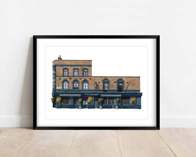 Watercolour giclée print of The Railway pub, Streatham, shown in a black frame.